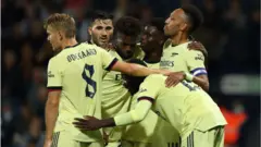 Arsenal players celebrate West Brom win