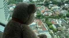 A teddy bear on a windowsill in Jakarta, Indonesia