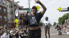 Demonstrators marching to defund the Minneapolis Police Department dance on University Avenue on June 6, 2020 in Minneapolis