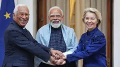 মুক্ত বাণিজ্য চুক্তি চূড়ান্ত হওয়ার পরে হাত মিলিয়েছেন ভারতের প্রধানমন্ত্রী নরেন্দ্র মোদী (মাঝে), ডান দিকে ইউরোপীয় কমিশনের প্রেসিডেন্ট উর্সুলা ভন ডের লেয়ন এবং বাঁয়ে ইউরোপীয় কাউন্সিলের প্রেসিডেন্ট এন্তোনিয়ো লুই সান্তোস দ্য কোস্টা