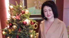 Eriko Kobayashi in a selfie by a Christmas tree