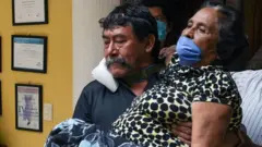 Relatives carry a woman with symptoms of Covid-19 in Chiapas state