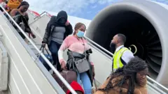 Group of pipo coming down from airplane