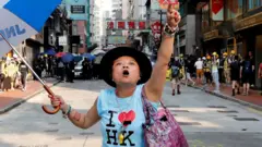 An anti-government demonstrator shouts toward Tsim Sha Tsui Police Station during a protest in Hong Kong, China, October 20, 2019.