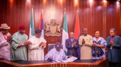 Nigeria President sign NIMC Act into law, oda top officials stand wit am