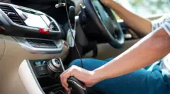 Man hand on car gear to drive the car