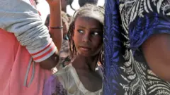Msichana wa Ethiopia akiwa ameseimama kwenye foleni kupokea chakula