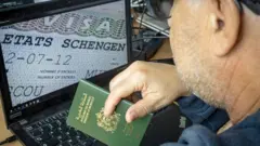Moroccan man holds his passport