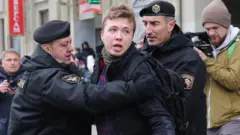 Police officers detain a journalist Roman Protasevich attempting to cover a rally in Minsk, Belarus, 26 March 2017