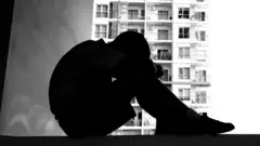 Boy sitting by window