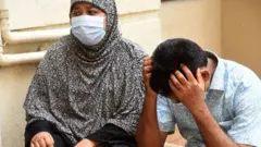 রক্ত পরীক্ষার অপেক্ষাঢ দু'জন।