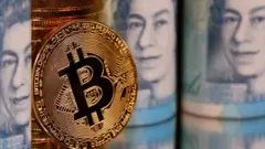 A representation of Bitcoin in front of some pound notes