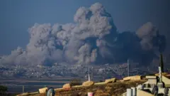 Smoke rising from buildings in Gaza after being hit by Israeli strikes on 1 December