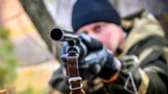 Man pointing a gun (stock photo)