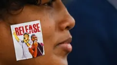 A demonstrators with a sticker on her cheek takes part in a protest against the Sri Lankan government and for the release of student leaders in Colombo on November 15, 2022.