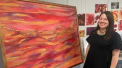 Lanson Moore with the painting into which her father's ashes will be added