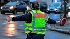 A German police officer directs traffic during a protest in berlin, January 2022