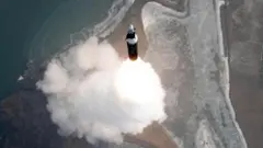 ধোঁয়ার কুণ্ডলি নিচে রেখে আকাশের দিকে উঠছে একটি ক্ষেপণাস্ত্র