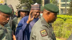 File photo of Malami accompanied by security operatives