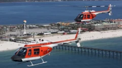 Two U.S. Navy TH-57C Sea Ranger helicopters conduct a formation training flight over Pensacola Beach, Fla.