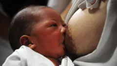 A mother breastfeeds her newborn baby at the Fabella Hospital in Manila