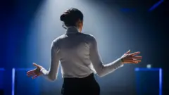 Successful Female Motivational Speaker on Stage