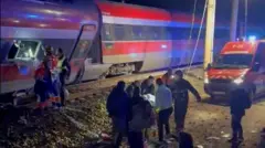 First responders search through wreckage after two high-speed trains derailed in Adamuz