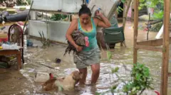 Una mujer intenta salvar a su pavo y a su perro de una inundación