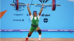 Adijat Adenike Olarinoye of Team Nigeria dey perform clean & jerk during Women Weightlifting 55kg Final on day two of di Birmingham 2022 Commonwealth Games 