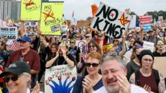 Many people holding may signs, with several saying 'no kings' on them.