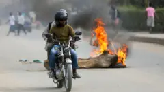 Pipo on top motorbike drive past one tree stump set wey dey burn for Luanda on Monday.