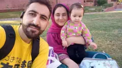 A selfie of a couple Rahim Shah and Bashira along with their baby daughter in a park 