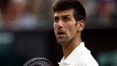 Novak Djokovic on court reacts with surprise