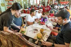 Uma garçonete serve hambúrgueres a um grupo de pessoas em um restaurante em Flat Rock, Carolina do Norte.
