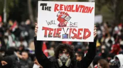 A person holds a placard, during a protest on the day Istanbul Mayor Ekrem Imamoglu was jailed as part of a corruption investigation, in Istanbul, Turkey, on 23 March 2025