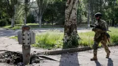 A Ukrainian serviceman walks near a shell of a multiple rocket launch system, as Russia"s attack on Ukraine continues, in Lysychansk, Luhansk region, Ukraine June 2, 2022.