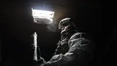 A Ukrainian serviceman on a front line near the city of Donetsk last month.