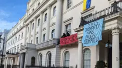 Squatters drape Ukrainian flags over the property