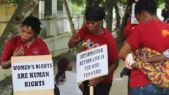 Advocacy group Abantu for development reps holding affirmative action placards 