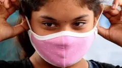 A girl wears a mask in Bangalore, India. Photo: 16 September 2020