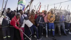 Various groups protest during one march against illegal immigrants on June 30, 2026 for Pretoria, South Africa. 