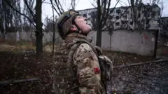 93-бригада аъзоси фронт ҳудудидаги Костянтинивка шаҳри осмонини дронлар учун кузатмоқда.
