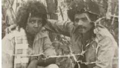መጎስ ብርሃነ ምስ በዓልቲ-ቤቱ ኣለም መሓሪ