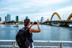 một khách du lịch chụp hình cầu Rồng tại Đà Nẵng