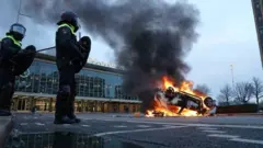 A car is set on fire in front of the train station on the 18 Septemberplein in Eindhoven on 24 January 2021