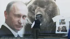 Vladimir Putin and a t-shirt that reads 'I'm a friend of Putin'