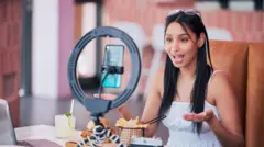 Woman influencer, food review blog and content creator filming online video in cafe restaurant. Creative live streaming, shooting 5g web vlog and virtual mobile phone app broadcast for social media