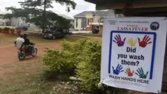 Foto show warning and awareness banner for Lassa fever wey dey dsiplay for di Institute of Lassa Fever Research and Control in Irrua Specialist Teaching Hospital in Irrua, Edo State