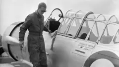The Duke of Edinburgh disembarks from a Harvard Trainer aircraft after a flight, at RAF White Waltham, Berkshire