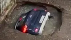 Car in hole in ground